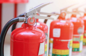 Photo of a group of fire extinguishers lined up.